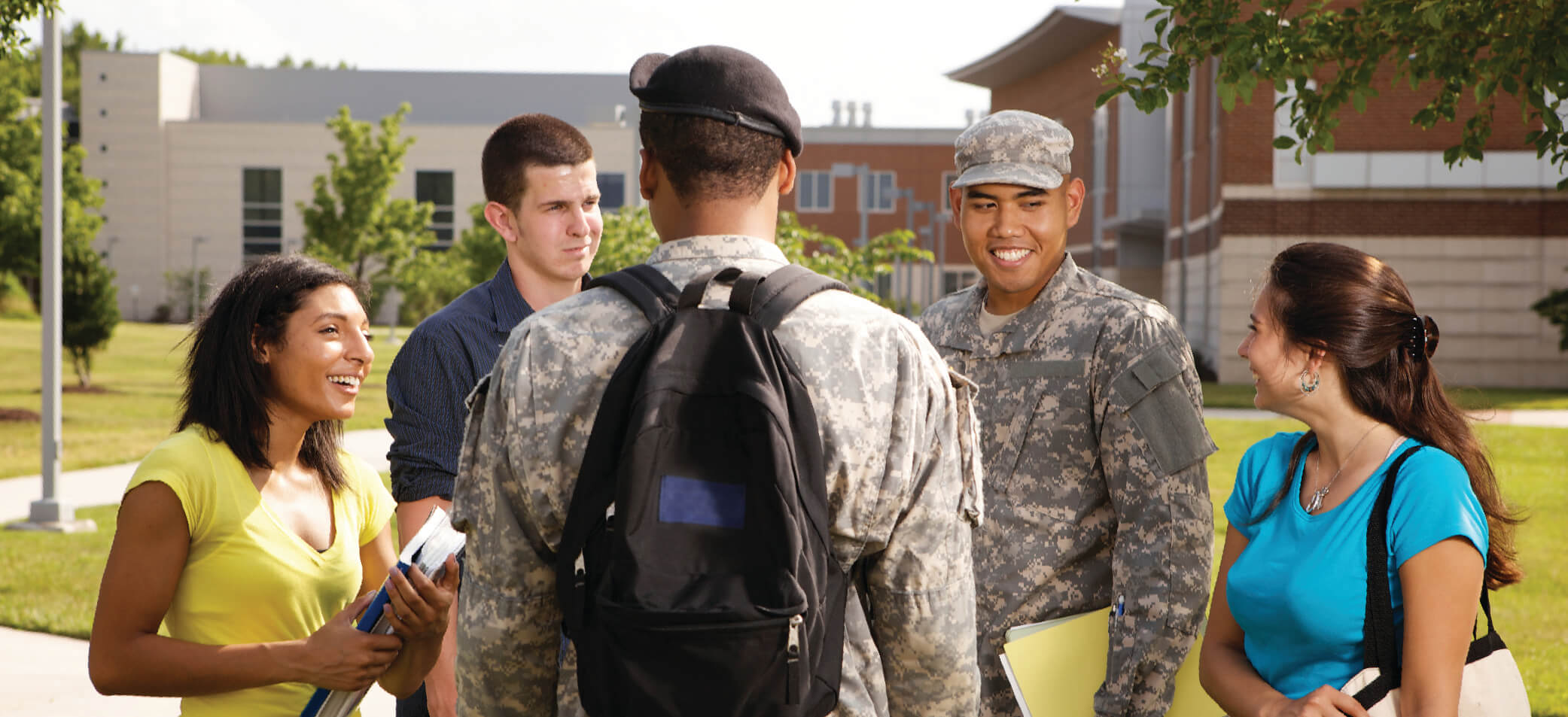 Student service members and other students gather on a campus