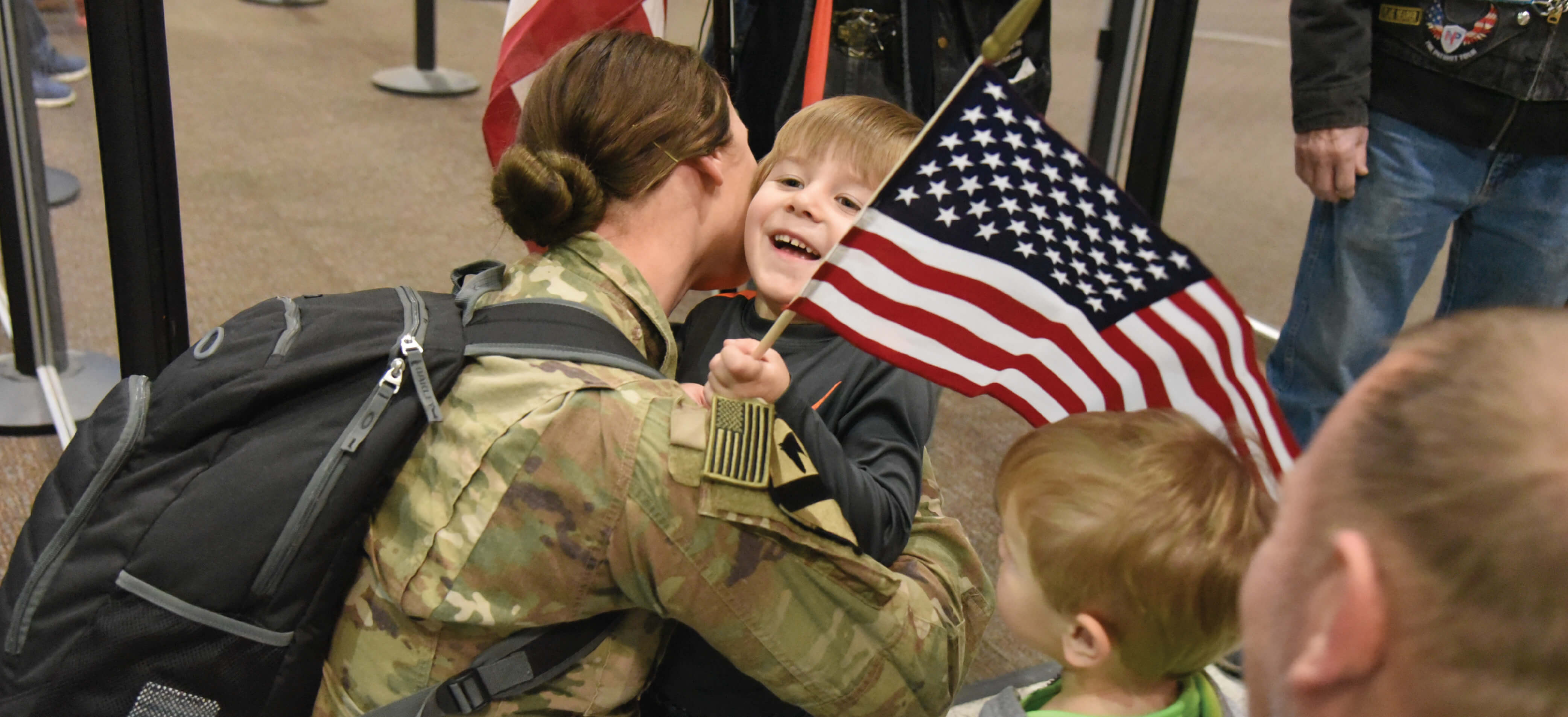 Army National Guard soldier hugs her son upon her return from deployment