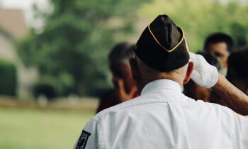 Veteran with POW-MIA patch saluting